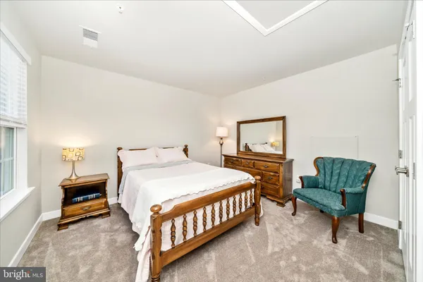 a bedroom with a bed and a night stand