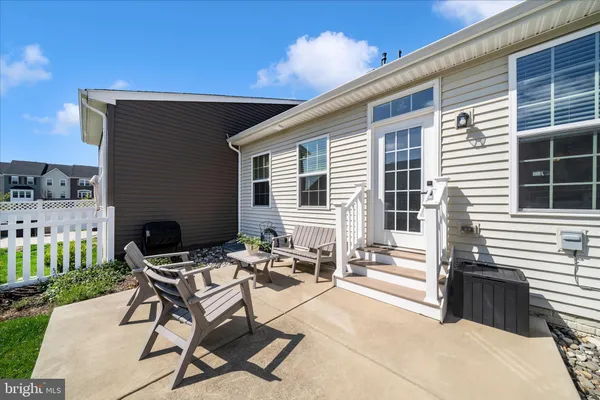 a view of a house with backyard porch and sitting area