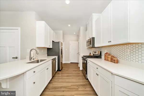 a kitchen with stainless steel appliances a stove microwave and a refrigerator