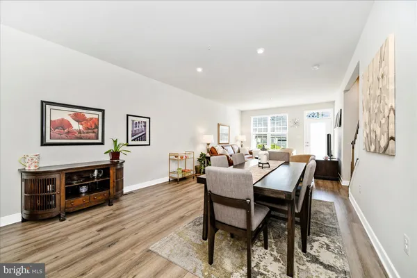 a dining room with furniture and wooden floor