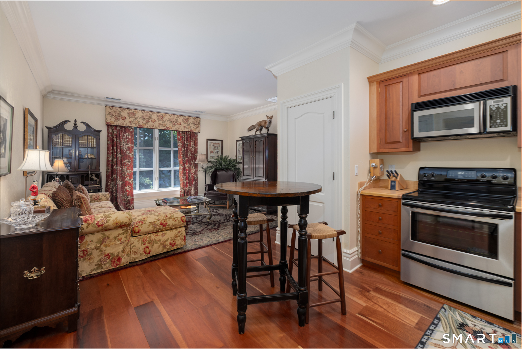 7 Equestrian Ridge Newtown, CT 06470 - Photo 35 of 40 a living room with furniture a fireplace and a flat screen tv