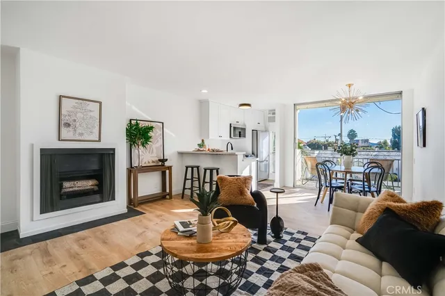a living room with furniture a dining table and a fireplace