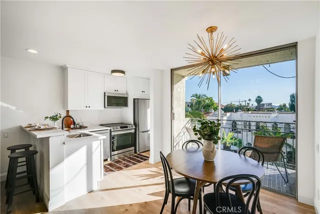 a view of a dining room with furniture and a chandelier