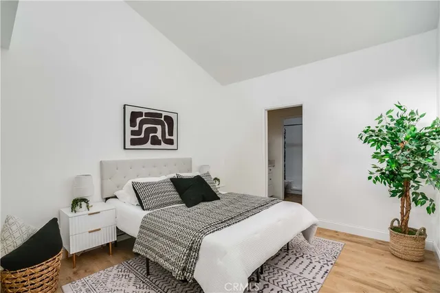 a bedroom with a bed and a potted plant
