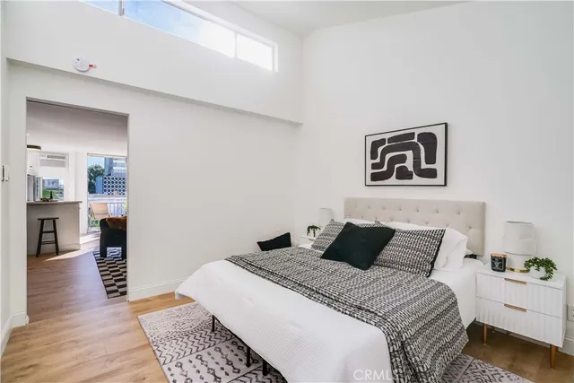 a bedroom with a bed and painting on the wall