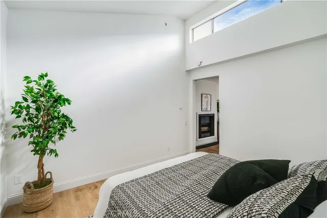 a bedroom with a bed and a potted plant