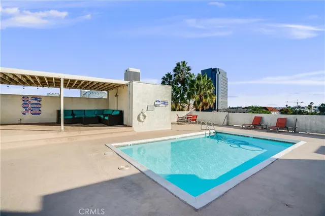 an outdoor space with swimming pool and furniture