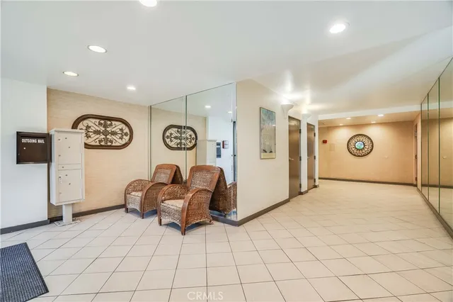 a living room with couch chairs and a large mirror on a dresser