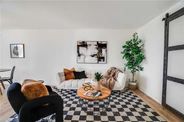 a living room with furniture and a potted plant