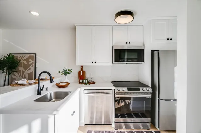 a kitchen with a sink a stove and cabinets