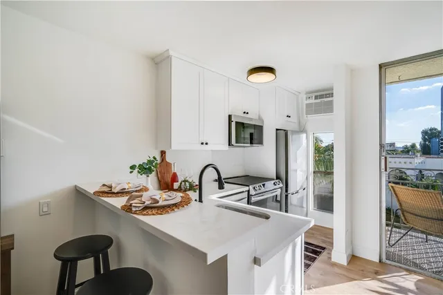a kitchen with a table chairs and a refrigerator