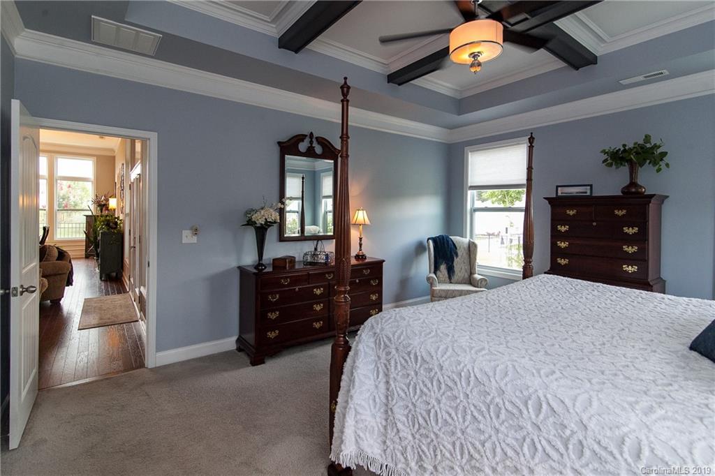 79026 Ridgehaven Road Lancaster, SC 29720 - Photo 16 of 30 a bedroom with a bed and dresser with mirror
