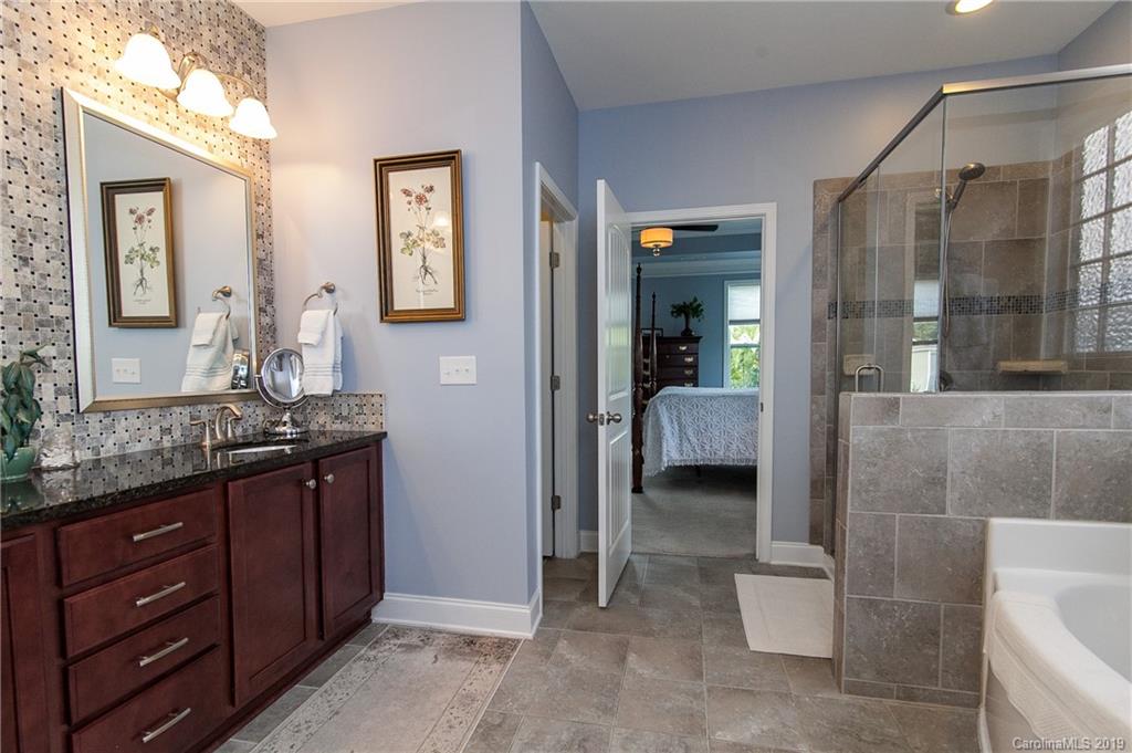 79026 Ridgehaven Road Lancaster, SC 29720 - Photo 19 of 30 a en suite bathroom with a granite countertop sink a toilet and a mirror