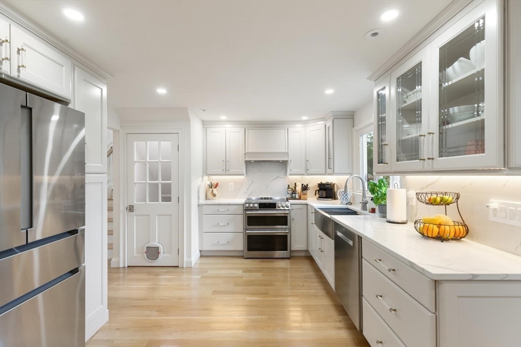 155 Adams Avenue Newton, MA 02465 - Photo 9 of 37 a large kitchen with stainless steel appliances and a refrigerator