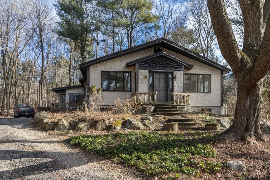 64 Hobbs Road Princeton, MA 01541 - Photo 20 of 22 a view of a house with a small yard plants and large tree