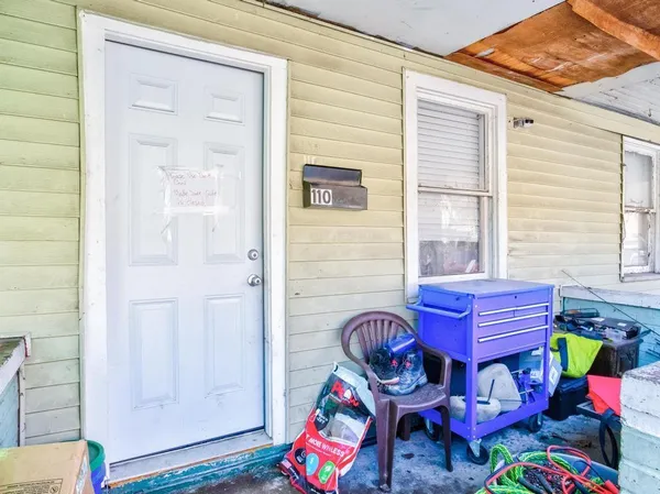 a view of a chairs and table in the backyard