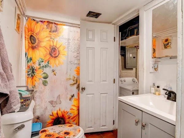 a bathroom with a sink toilet and shower