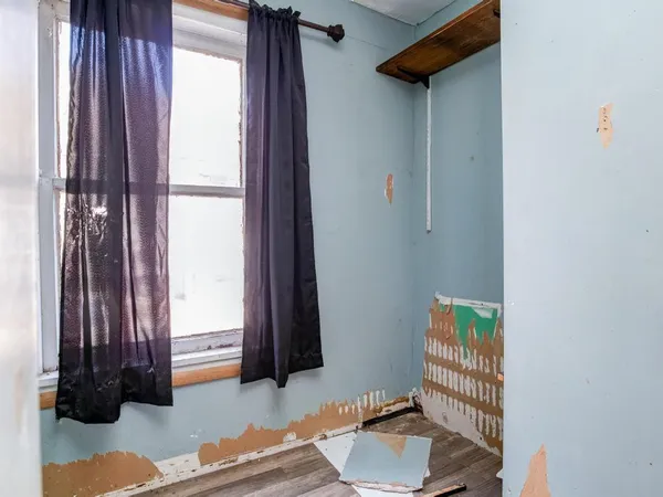 a view of porch with a table and chairs