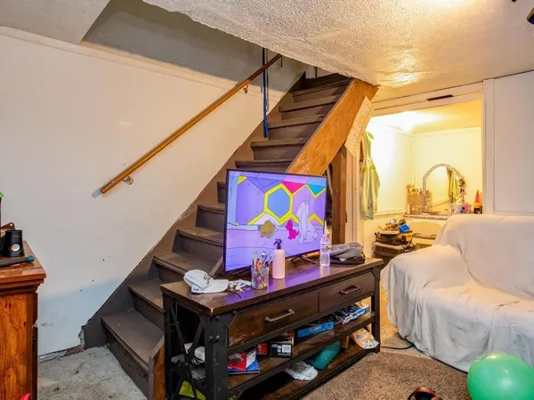 a bedroom with bed and a flat screen tv