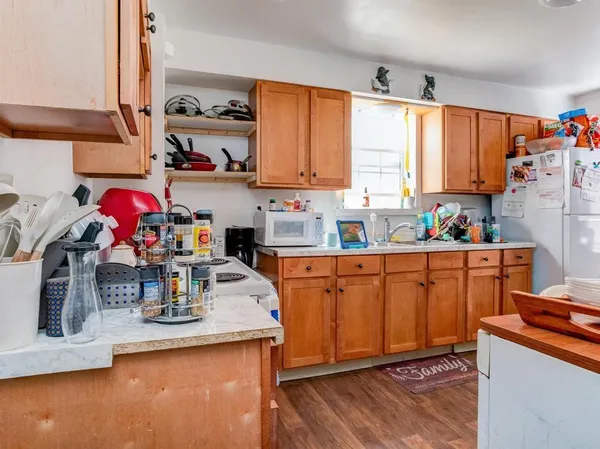 a room with furniture a flat screen tv and a window