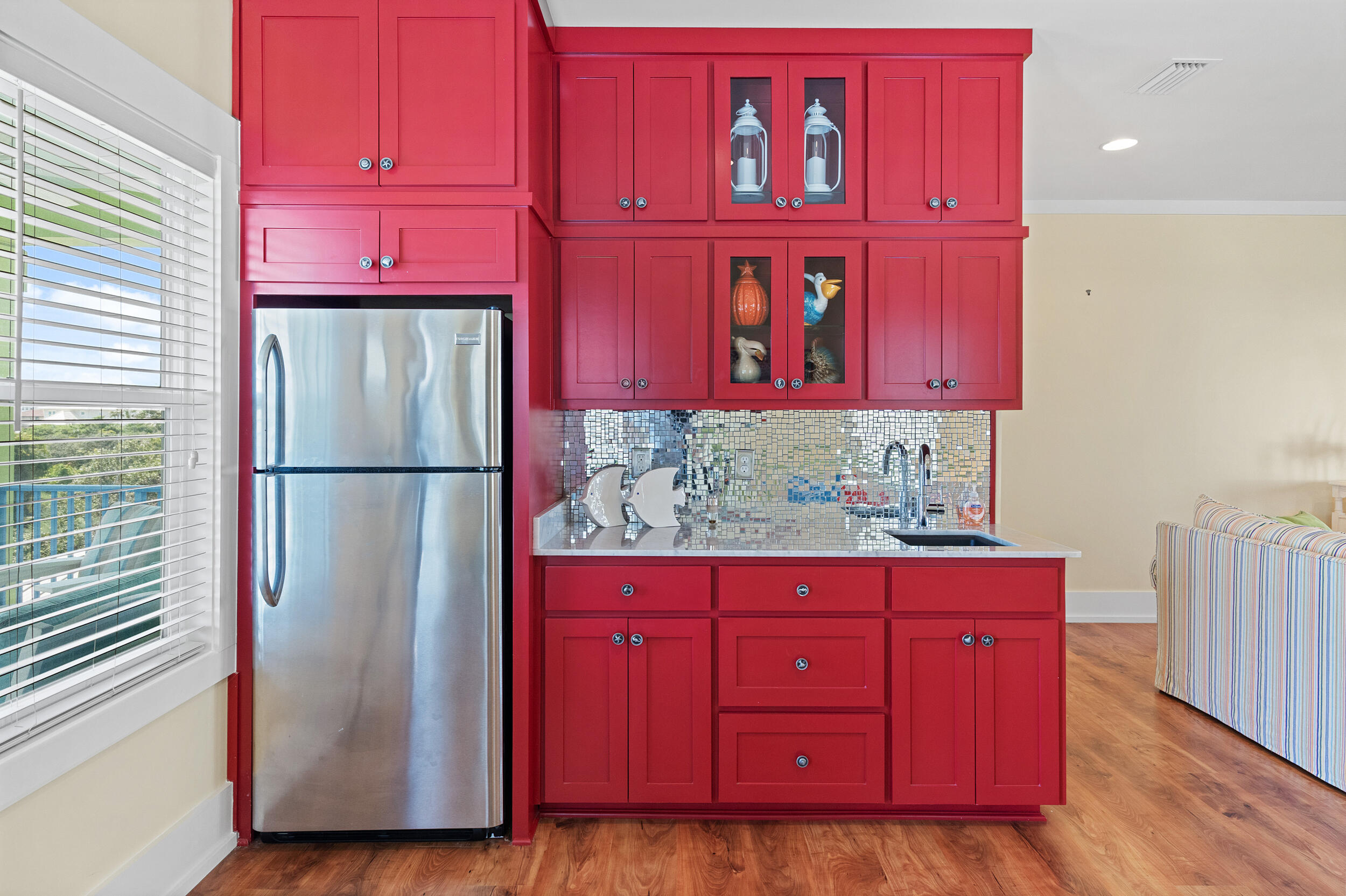 34 Blue Dolphin Loop Inlet Beach, FL 32461 - Photo 37 of 45 a kitchen with red cabinets and wooden floor