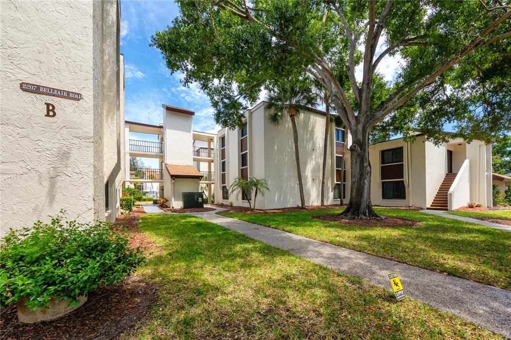 2207 Belleair Road, Unit B30 Clearwater, FL 33764 - Photo 35 of 39 a view of a house with backyard and a tree