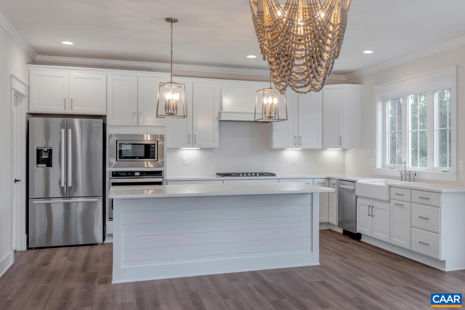 151 Agatha Ridge Lane Crozet, VA 22932 - Photo 24 of 52 a kitchen with stainless steel appliances granite countertop a sink a refrigerator and wooden floor