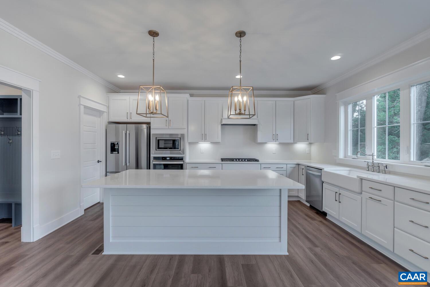 151 Agatha Ridge Lane Crozet, VA 22932 - Photo 26 of 52 a large kitchen with stainless steel appliances a large counter tops a stove a sink dishwasher and a wooden cabinets