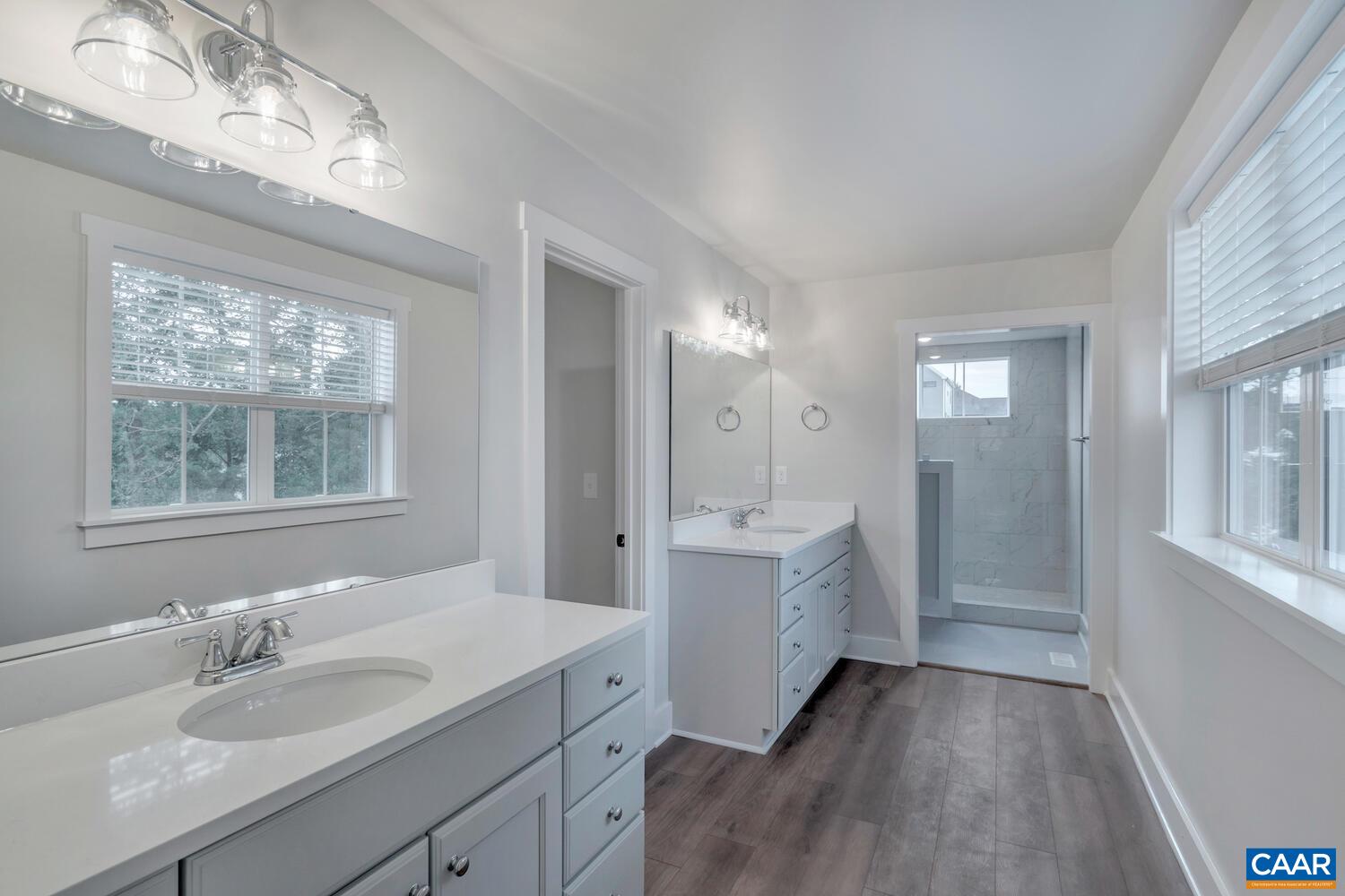 151 Agatha Ridge Lane Crozet, VA 22932 - Photo 43 of 52 a bathroom with a double vanity sink a mirror and a bathtub