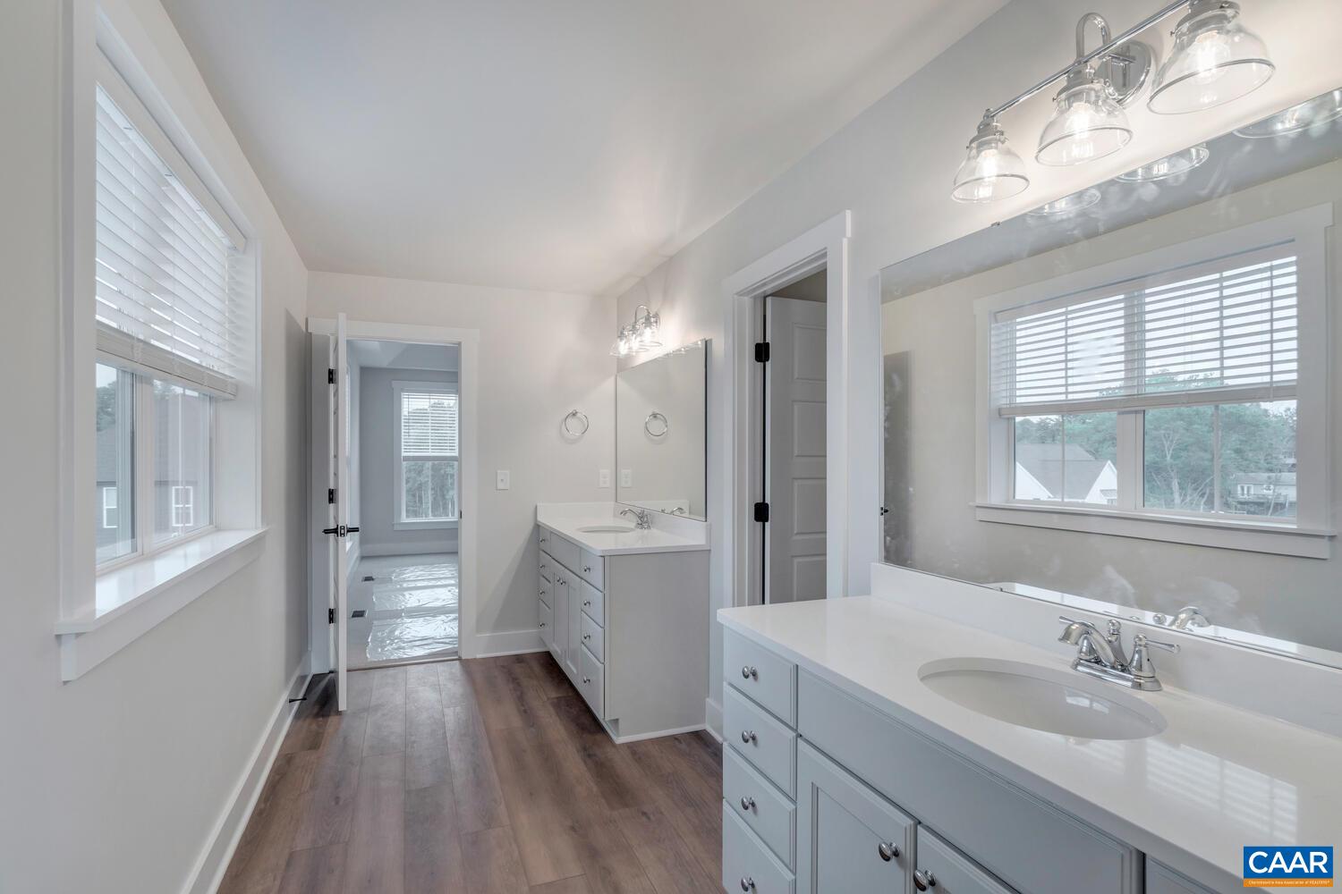 151 Agatha Ridge Lane Crozet, VA 22932 - Photo 44 of 52 a bathroom with a double vanity sink a mirror and a shower