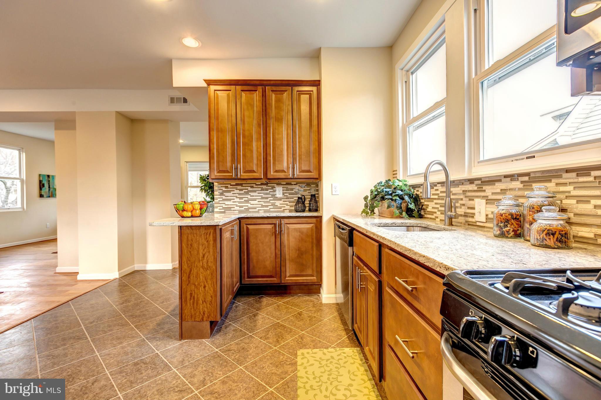 4501 Raspe Avenue Baltimore, MD 21206 - Photo 13 of 30 Kitchen With Tile Backsplash