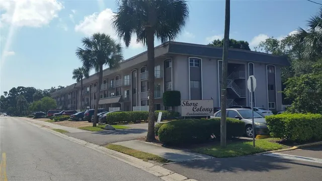 a view of a house with a yard and tree s