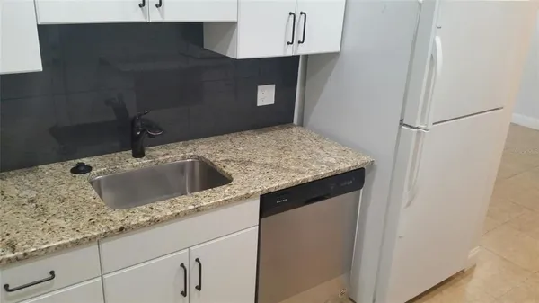 a kitchen with a sink and cabinets