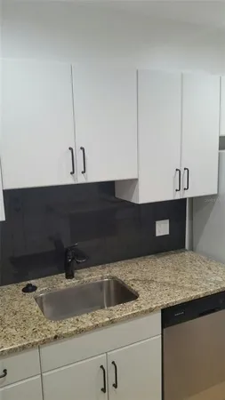 a kitchen with a sink and cabinets