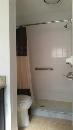 a bathroom with a toilet and a shower