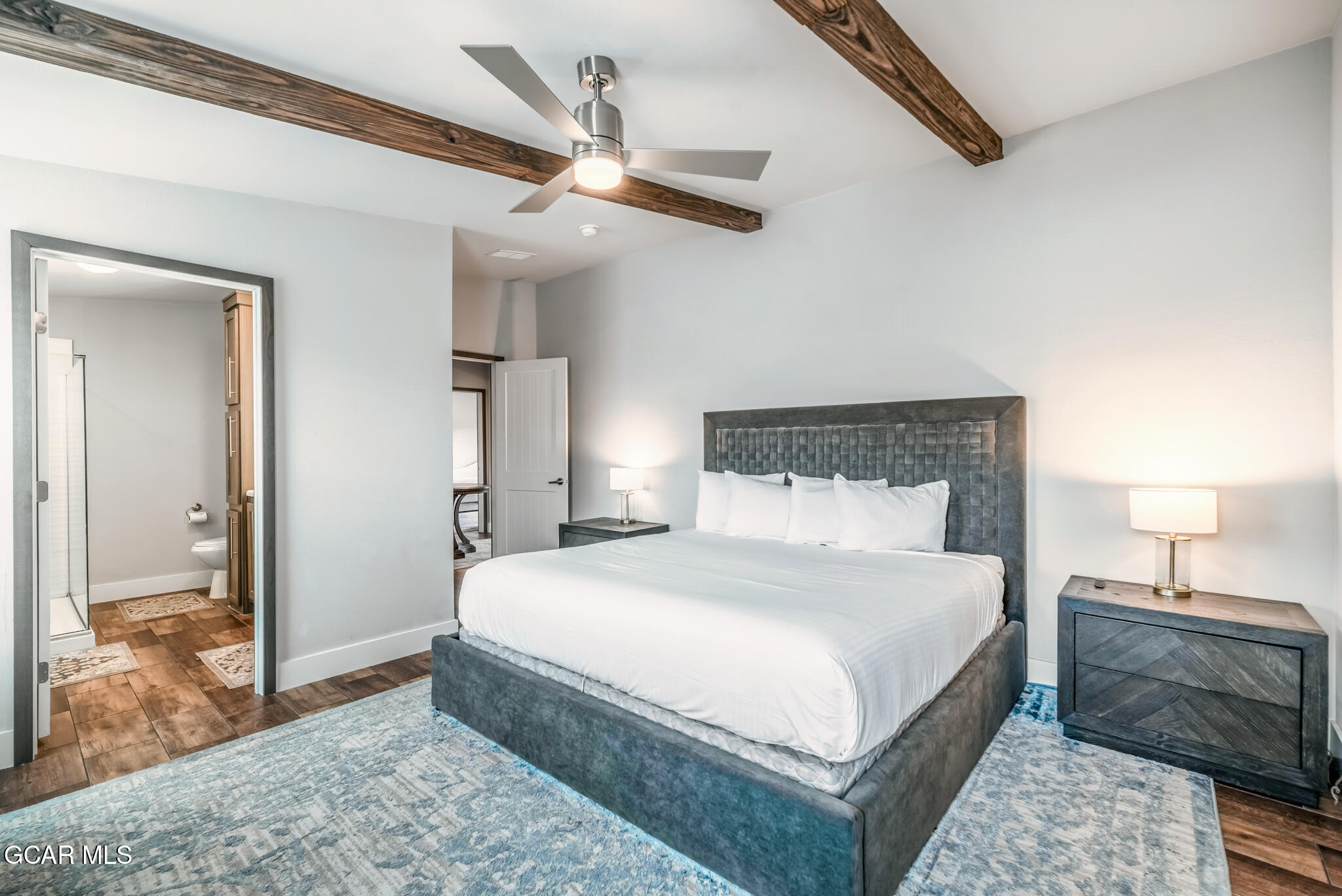 1051 Summit Trail Granby, CO 80446 - Photo 14 of 66 a bedroom with a large bed and a chandelier fan