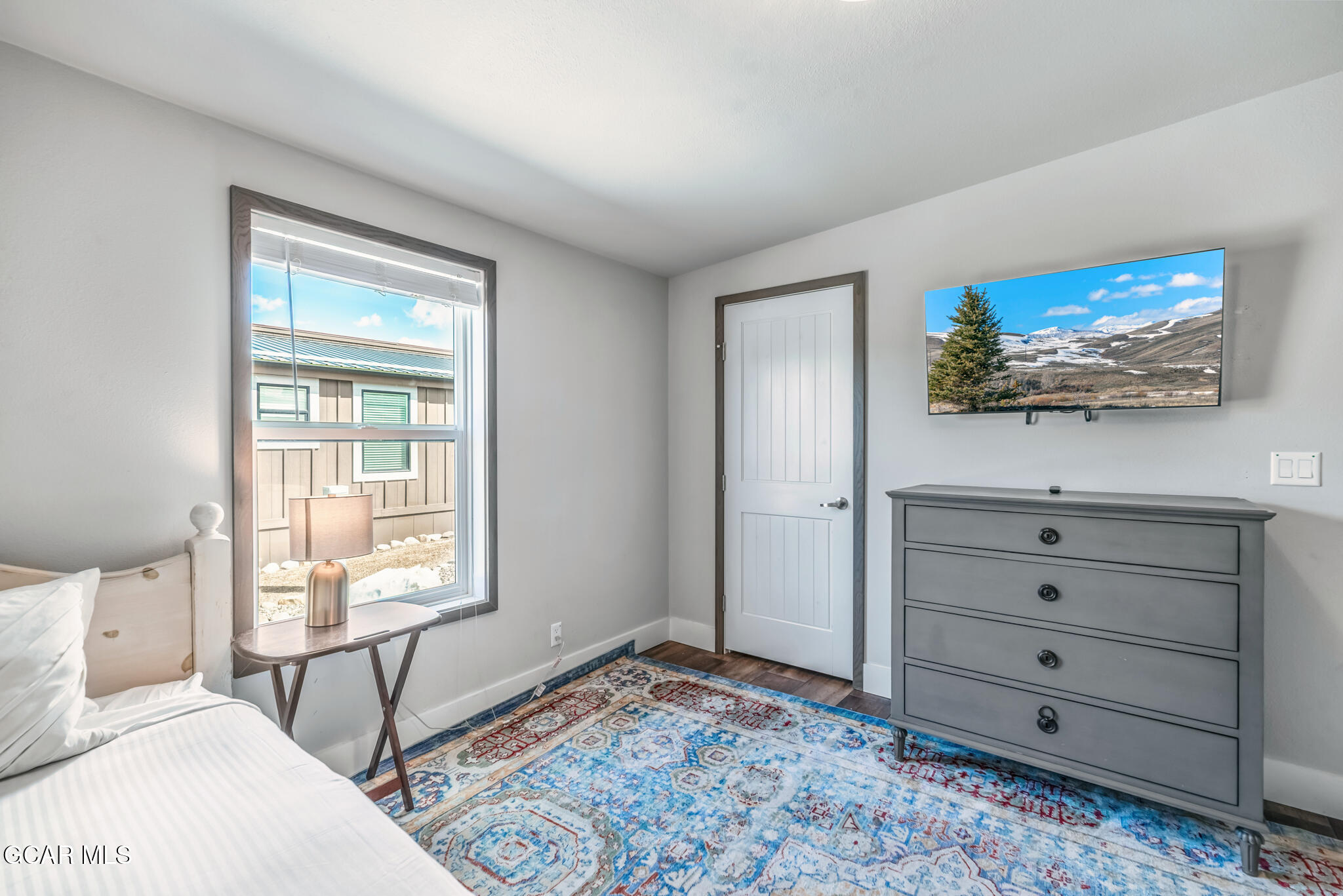 1051 Summit Trail Granby, CO 80446 - Photo 20 of 66 a bedroom with a bed and a flat screen tv
