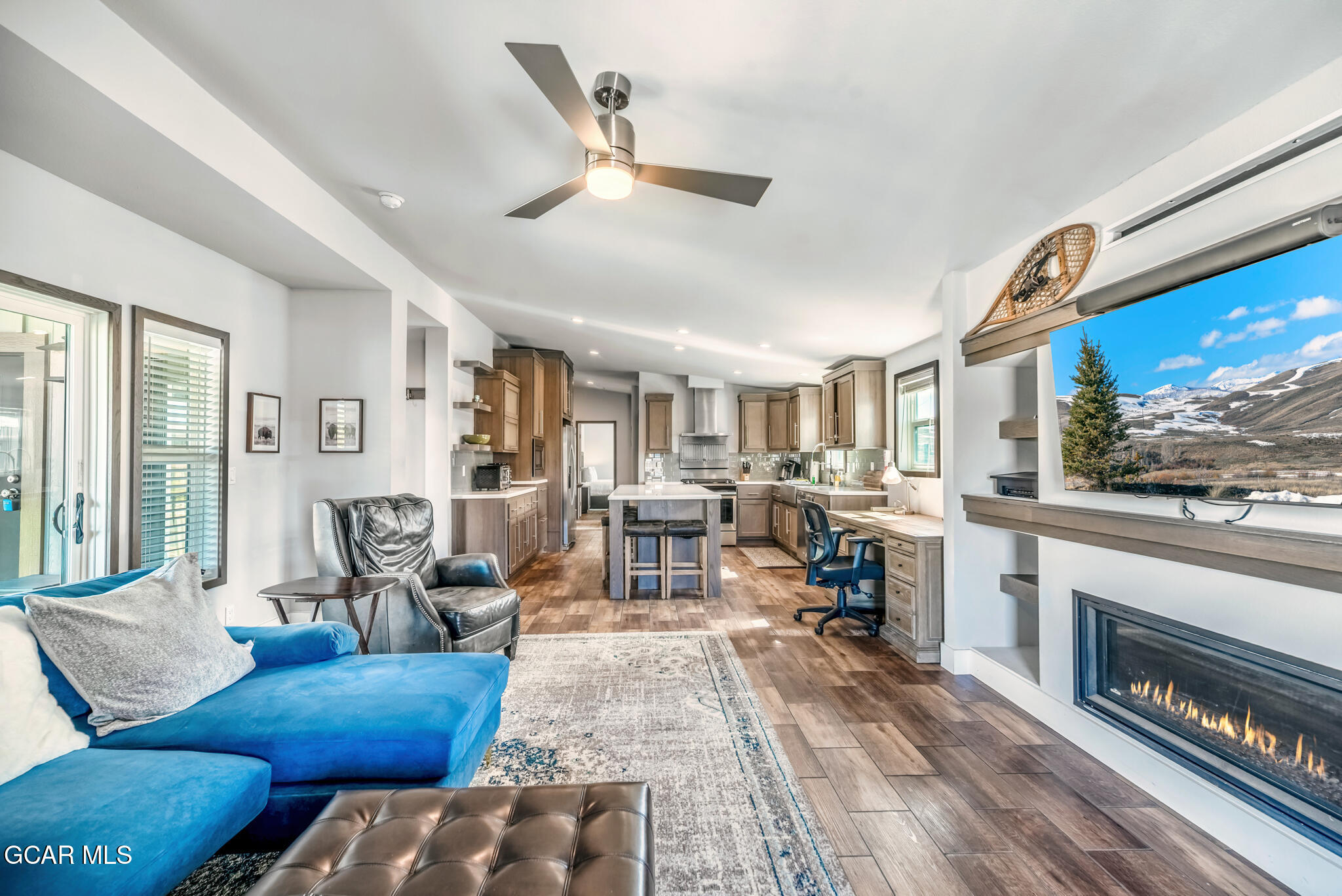 1051 Summit Trail Granby, CO 80446 - Photo 42 of 66 a living room with furniture a fireplace and a floor to ceiling window