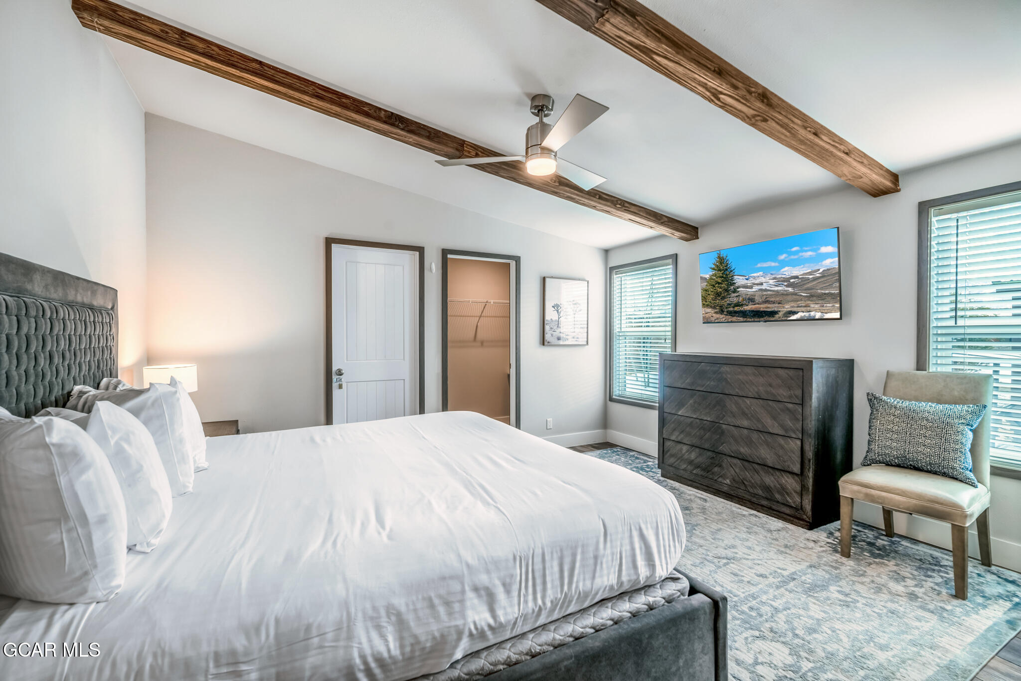 1051 Summit Trail Granby, CO 80446 - Photo 10 of 66 a bedroom with a bed a dresser and chair