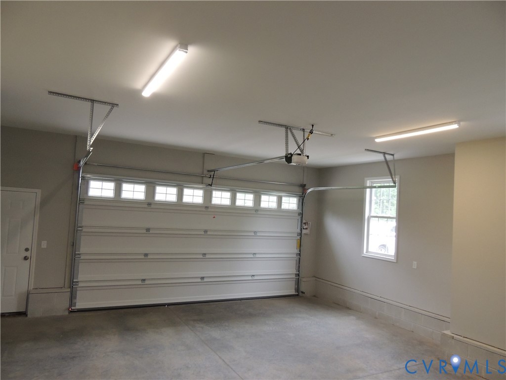 4417 Olgers Road Sutherland, VA 23885 - Photo 23 of 24 Spacious garage featuring a concrete floor, overhe