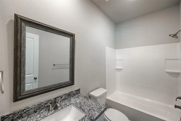 a bathroom with a shower and a toilet sink