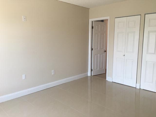 4154 Inverrary Drive, Unit 407 Lauderhill, FL 33319 - Photo 19 of 39 an empty room with closet area