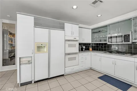 a view of an empty room with wooden floor and windows
