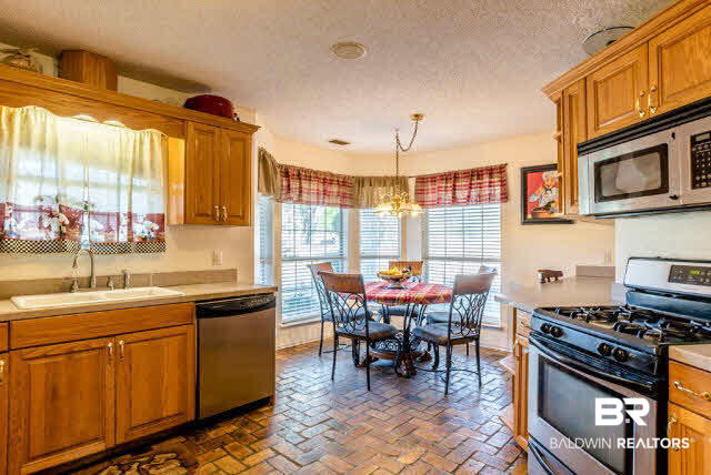 7412 Lott Road Wilmer, AL 36587 - Photo 8 of 25 Split brick floors in kitchen.