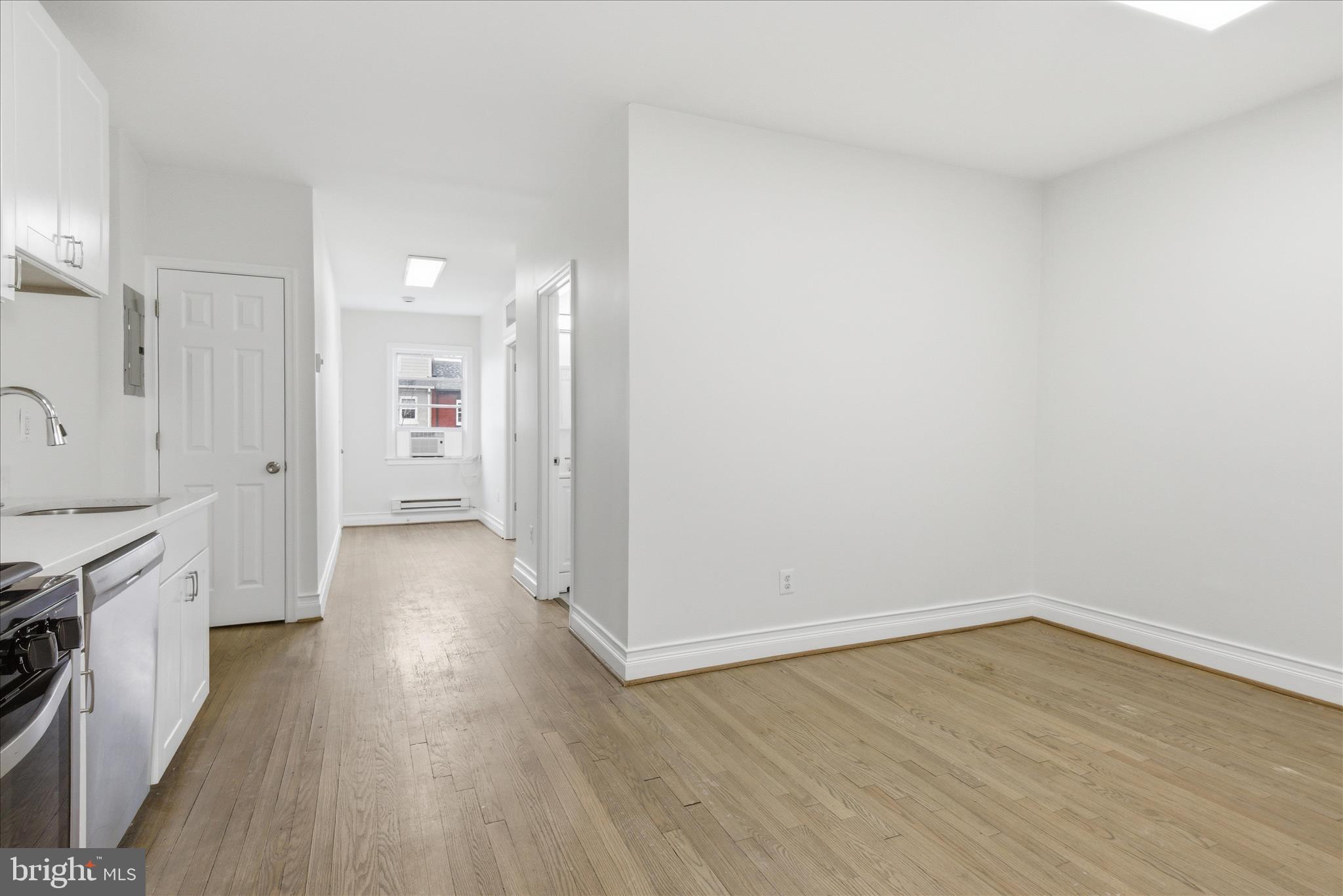 221 20th Street Northeast, Unit 3 Washington, DC 20002 - Photo 11 of 30 a view of a kitchen with wooden floor and a sink