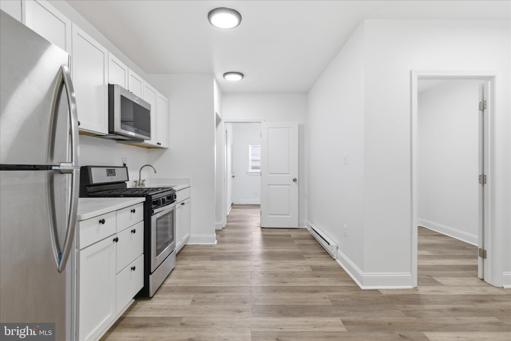 221 20th Street Northeast, Unit 3 Washington, DC 20002 - Photo 12 of 30 a kitchen with stainless steel appliances granite countertop a refrigerator and a stove top oven