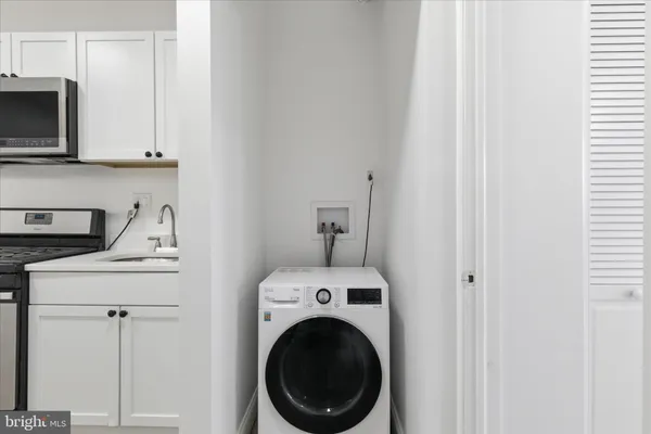 a view of a kitchen with washer and dryer