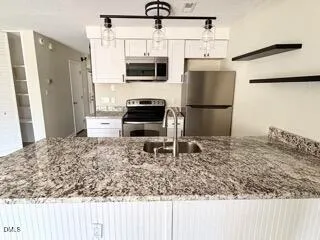 a kitchen with a refrigerator sink and stove