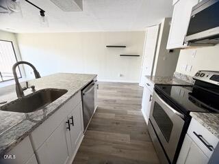 3071 Huntleigh Drive, Unit 3071 Raleigh, NC 27604 - Photo 13 of 25 a kitchen with granite countertop a sink and a stove top oven