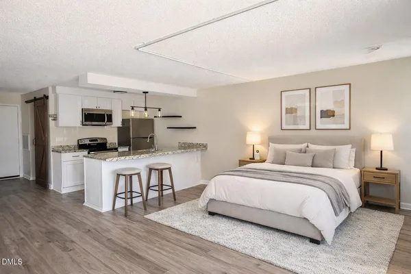 a bedroom with a bed and a television
